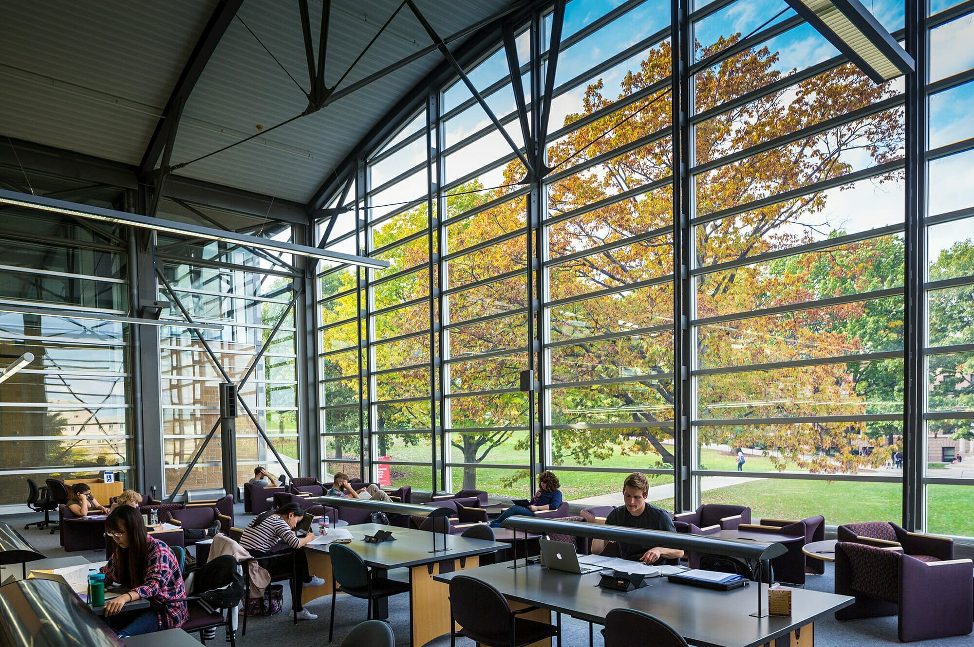 Interior shot of the law library with large curving window frame and Bascom Hill outside
