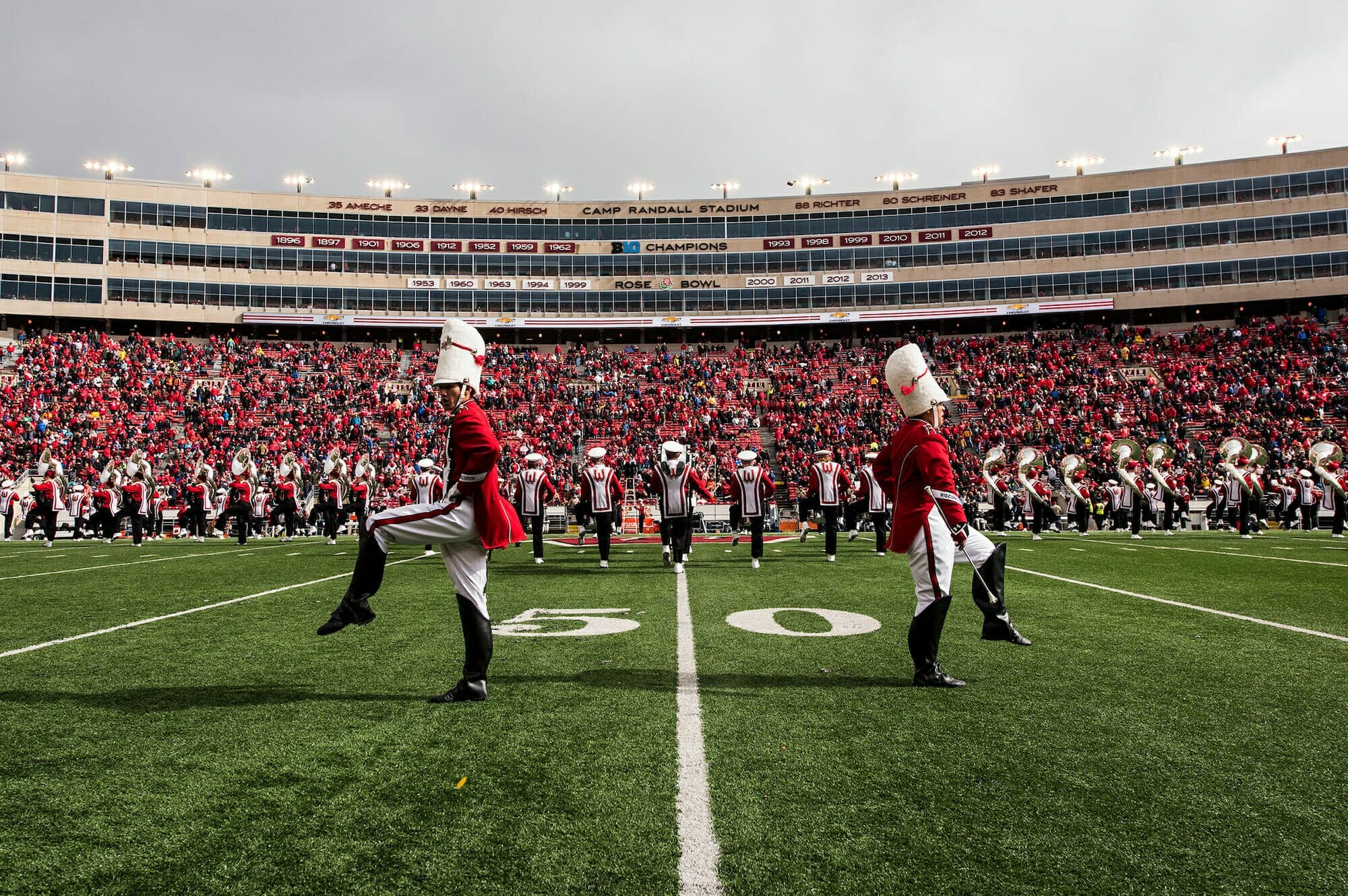 A pair of drum majors march at the UW Marching Band performs at Camp Randall