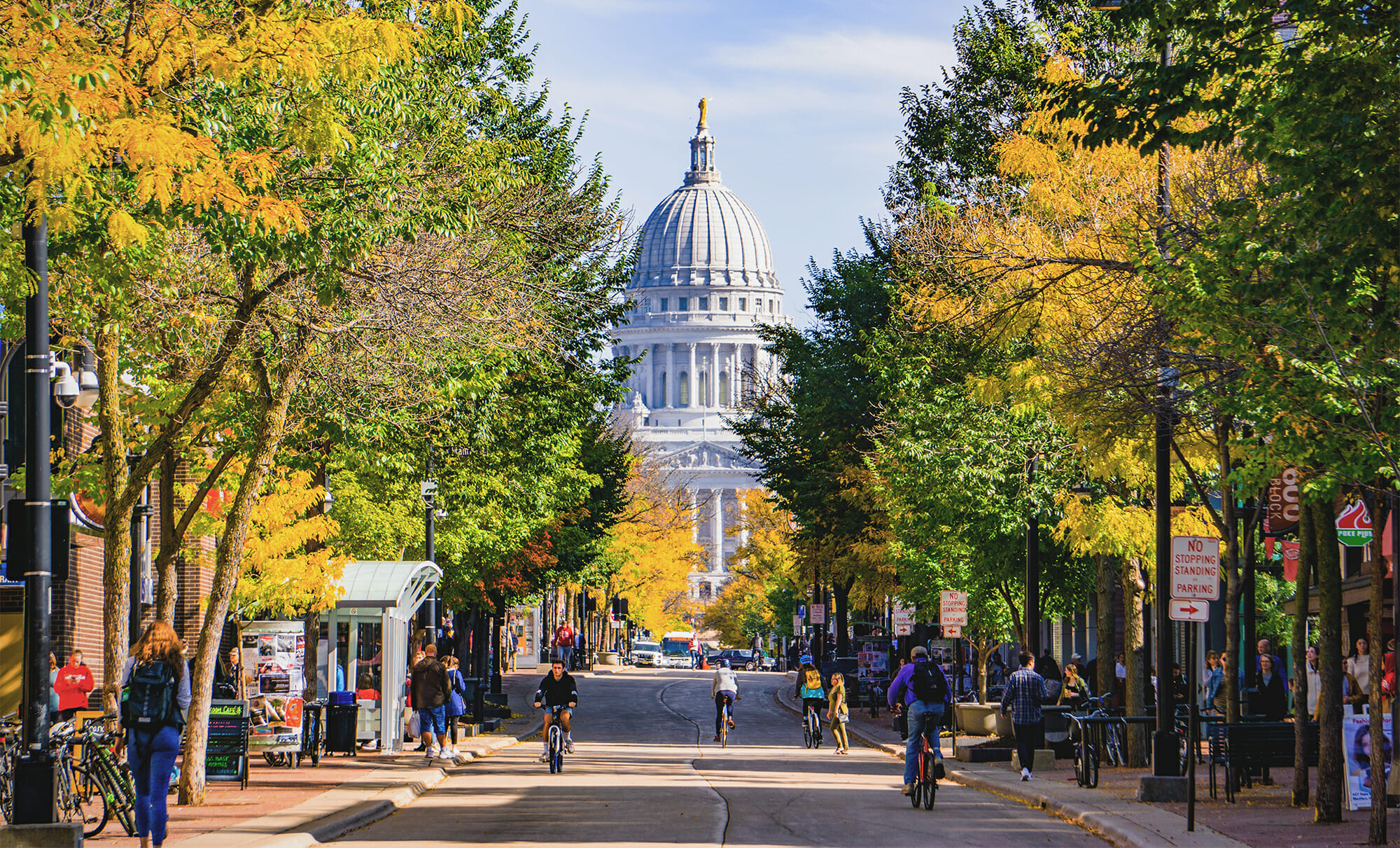 Long shot of tree-lined State Street looking toward the Capitol building in fall