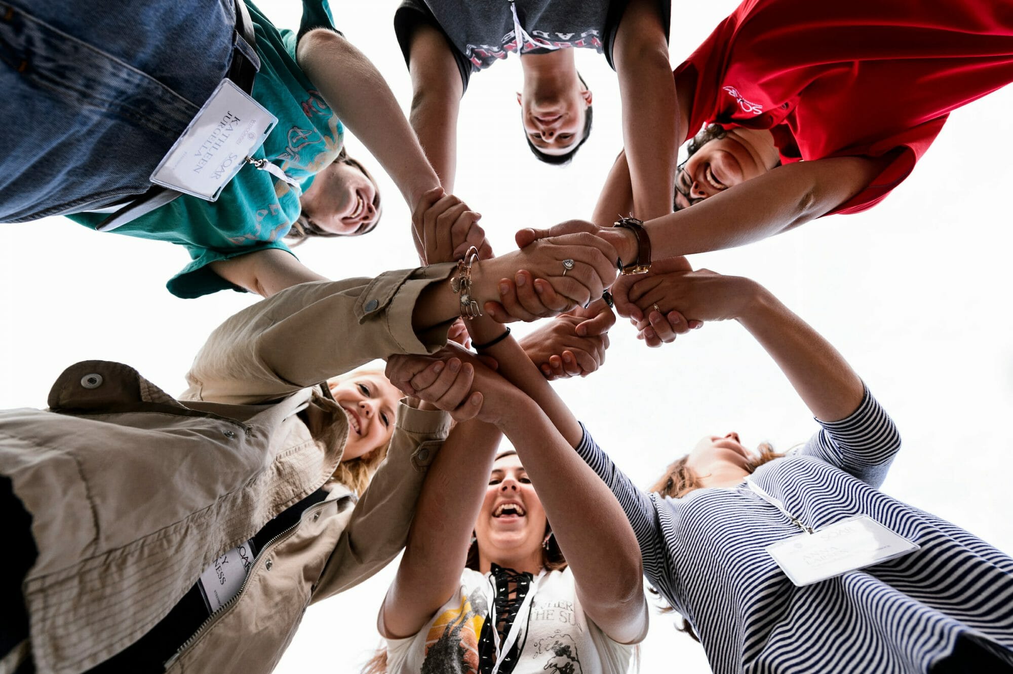 Students join hands in a circle