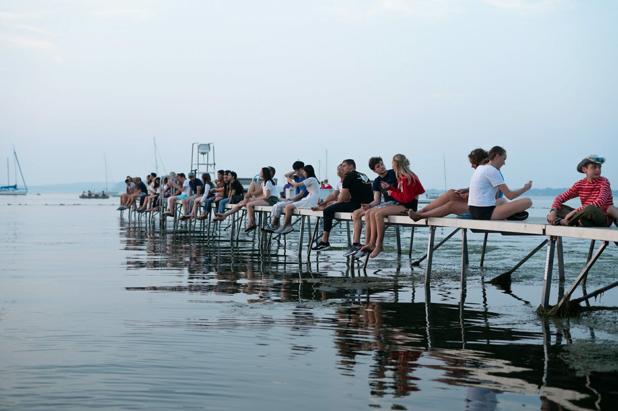 People line a dock at the Terrace at dusk